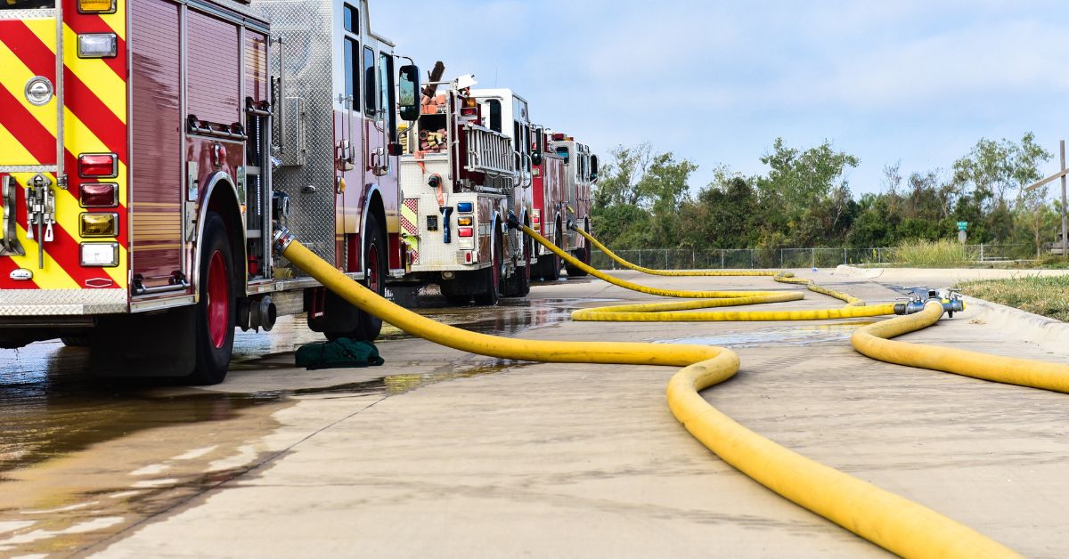Firetrucks with yellow hose