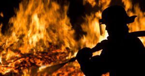 Firefighter silhouette in a big fire background