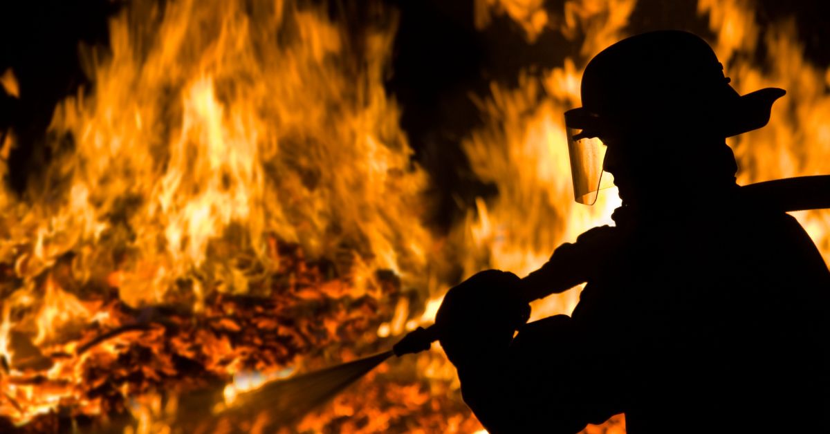 Firefighter silhouette in a big fire background
